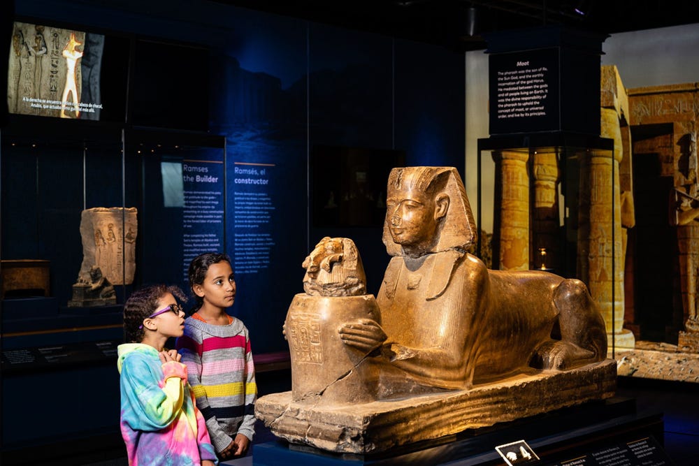 Photograph of children viewing sphinx at Ramses exhibition
