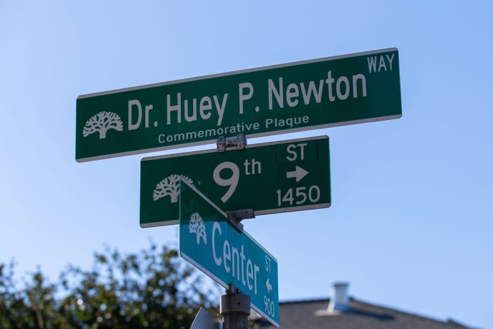 street sign showing Dr. Huey P. Newton  Way