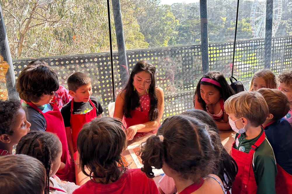 Teacher instructing students in art activity at the de Young