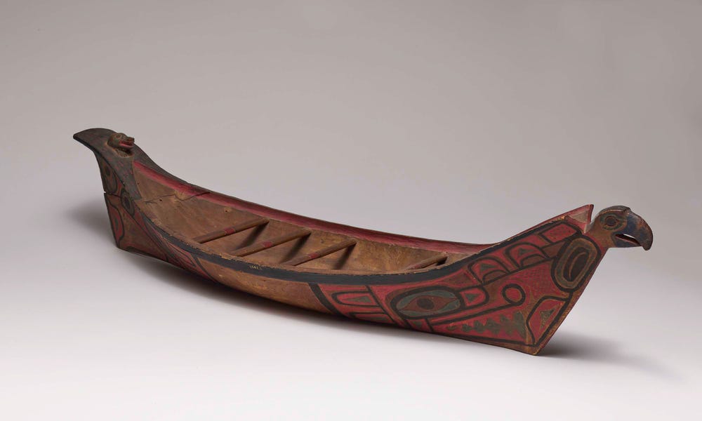 carved boat with painted designs