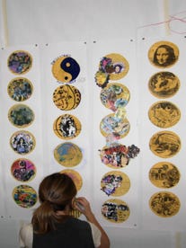 person looking at tortillas displayed on a wall