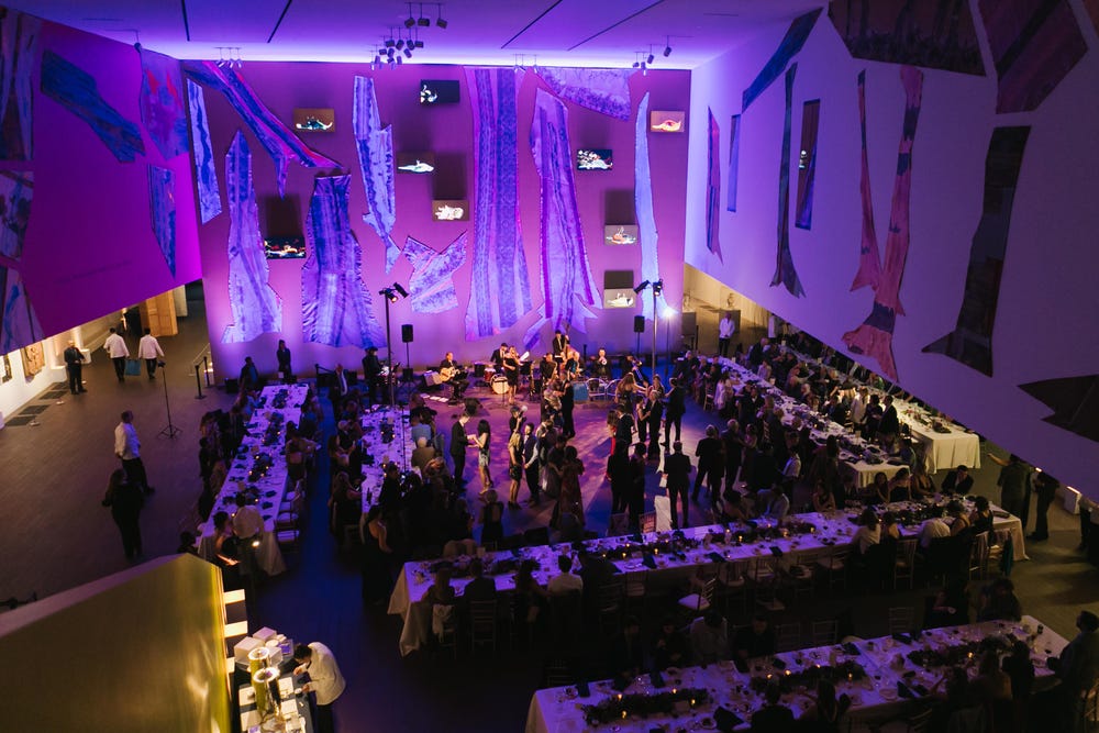de Young Wilsey Court decorated and filled with performers during an event