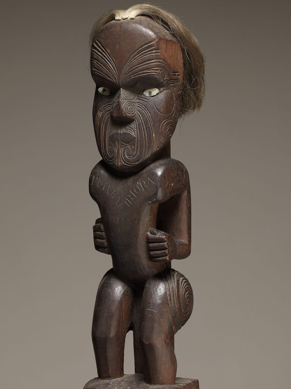 Intricate wooden sculpture of human figure with hair