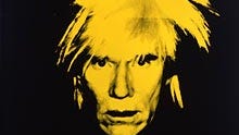 Andy Warhol's face in with hair sticking up in bright yellow against a black background