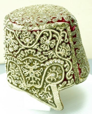 Woman's fez with freshwater pearls, the imperial double eagle on the front, the decoration of thick gold braid on red velvet;