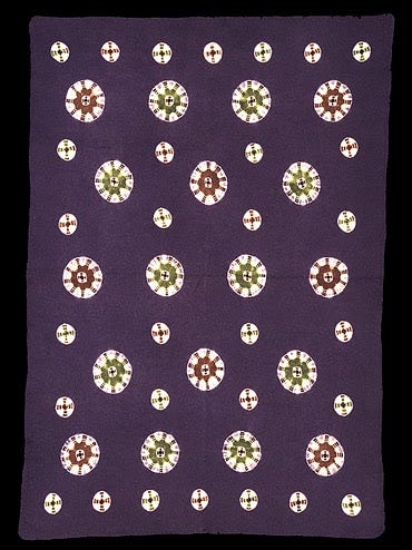 Purple mat with green and red pattern.