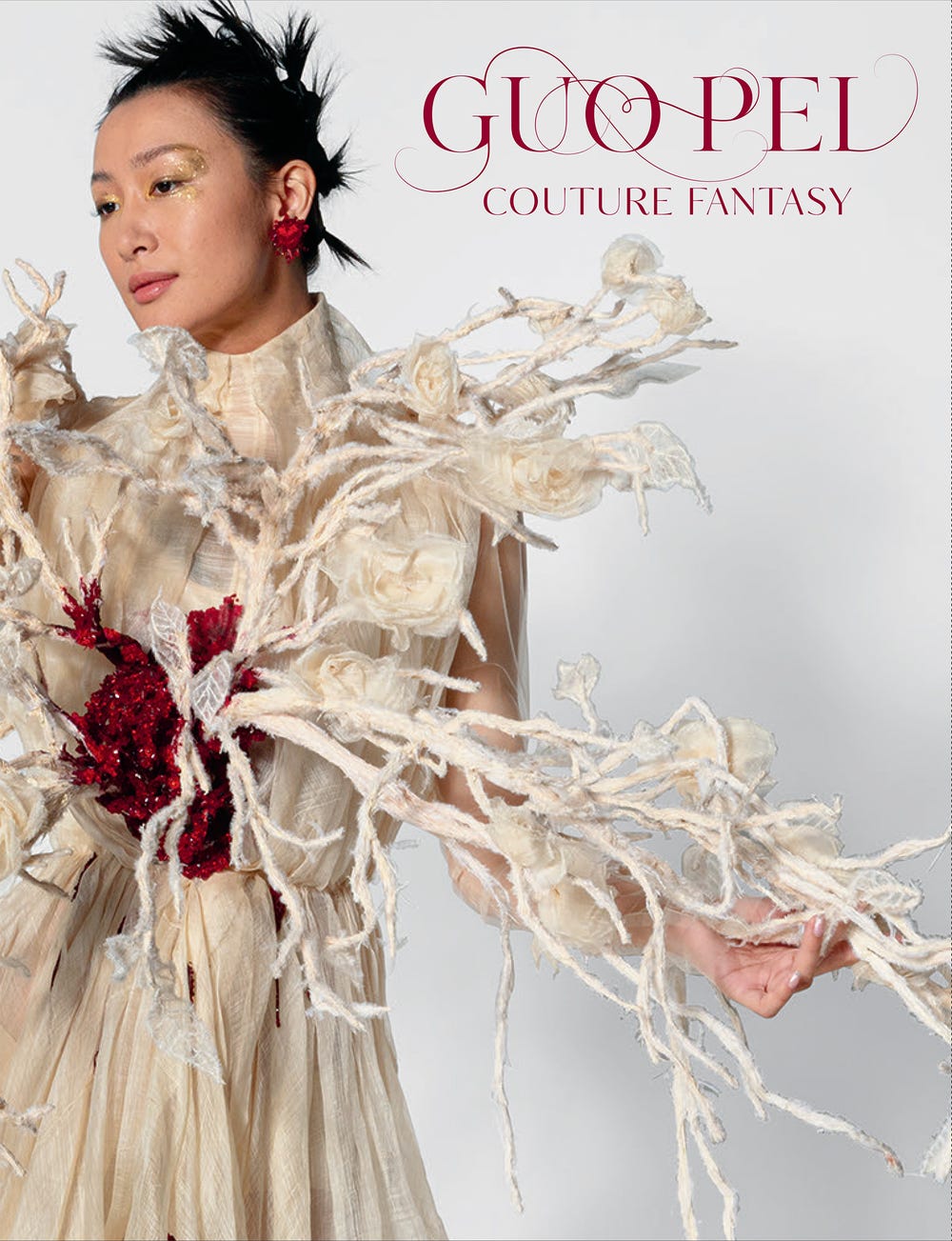 Book jacket featuring model in intricate white dress with "Guo Pei Couture Fantasy" text