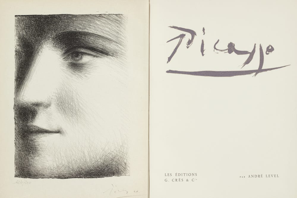 Open pages of a book with a drawing of a face on the left side and “Picasso” on the right