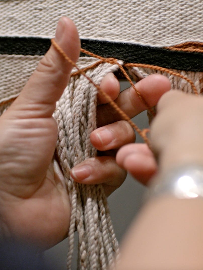 Hands working with yarn