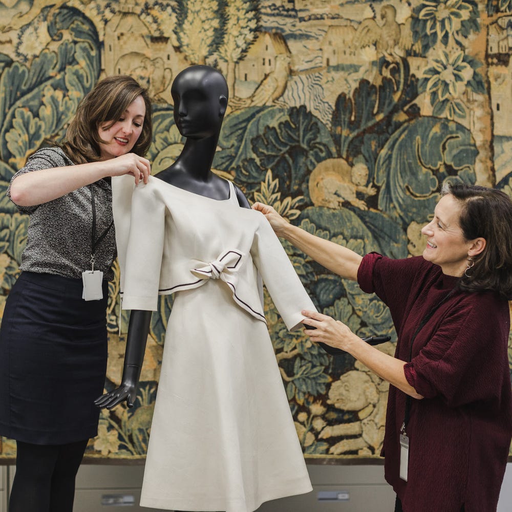 Fine Arts Museums of San Francisco conservation staff dressing a mannequin