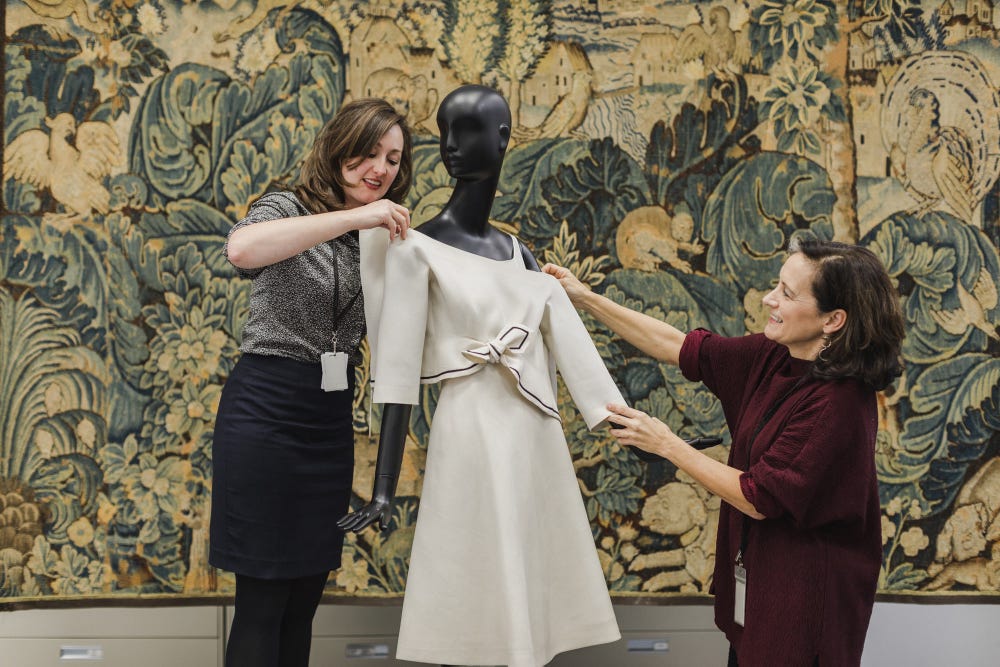 Fine Arts Museums of San Francisco conservation staff dressing a mannequin