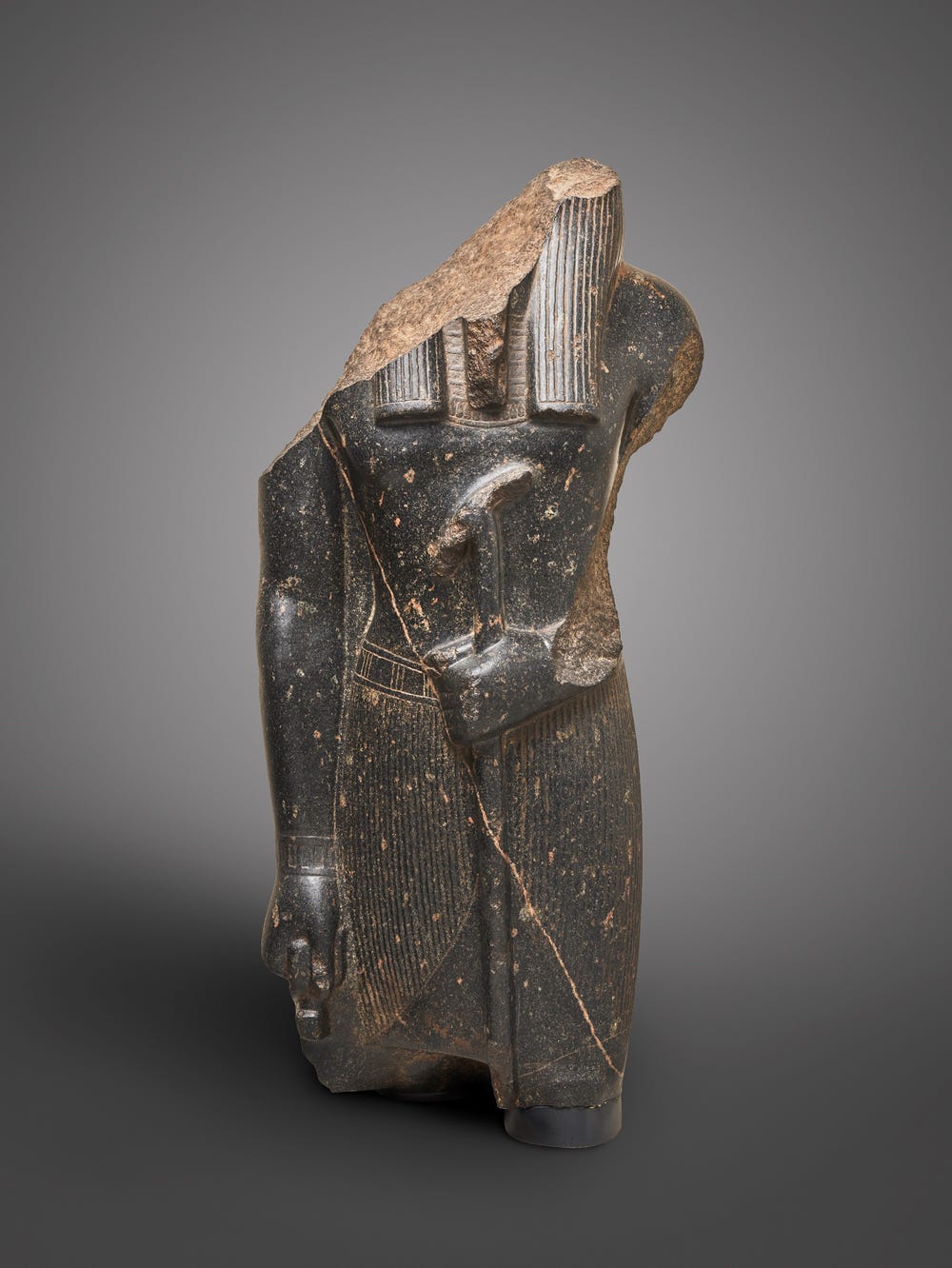 partial sculpture showing the torso of a god