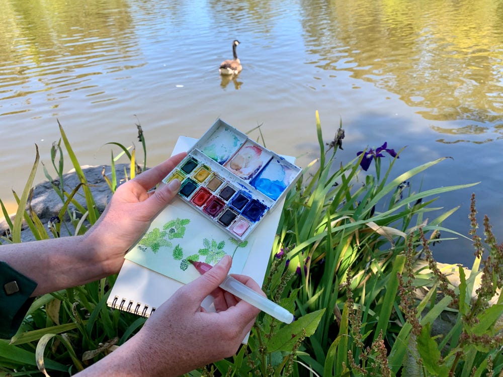 making a small watercolor by a lake