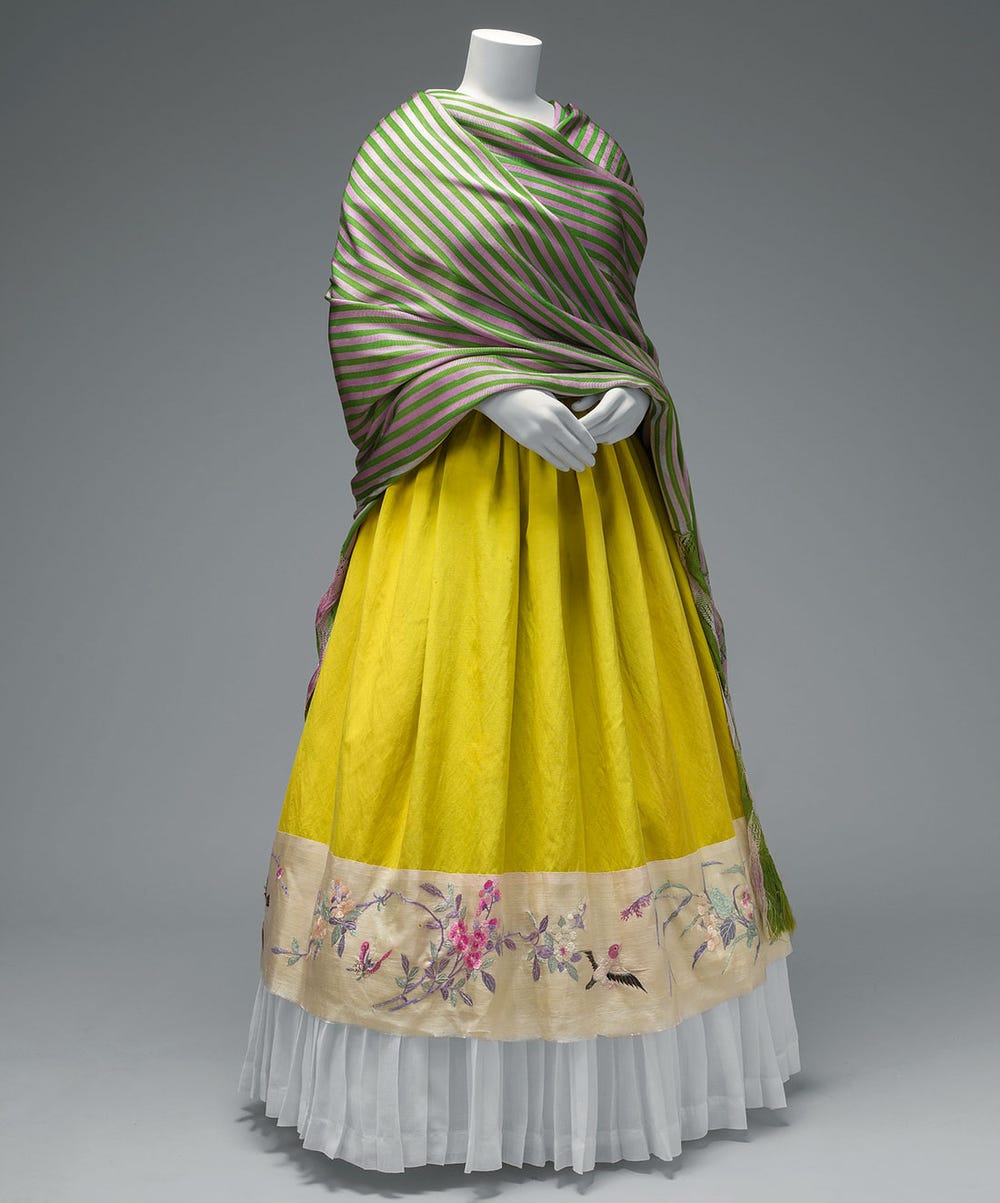 Green and pink rebozo with rapacelo (knotted fringe); silk skirt with Chinese embroidered panel and holán (ruffle)