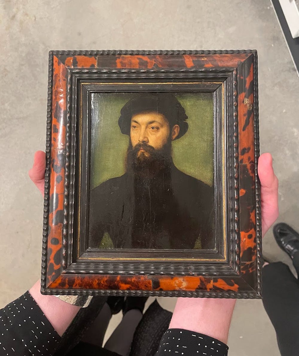 Hands holding a portrait of a man