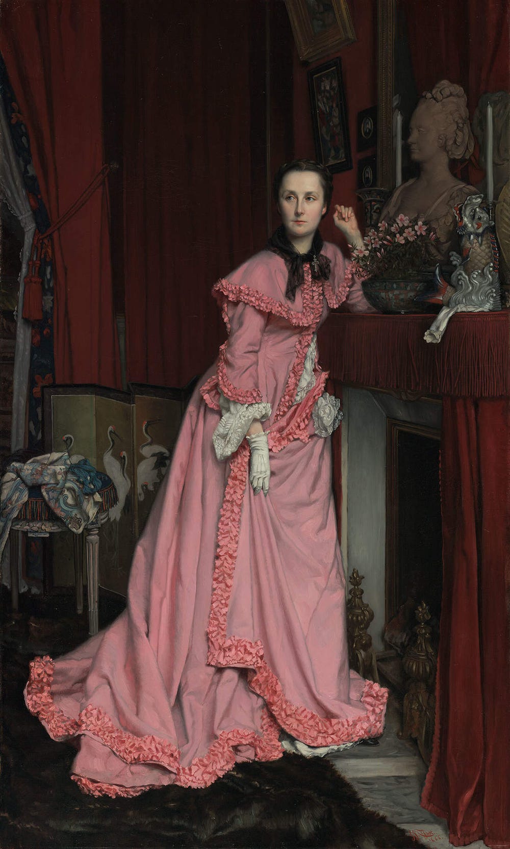 Woman wearing a pink dress and white gloves