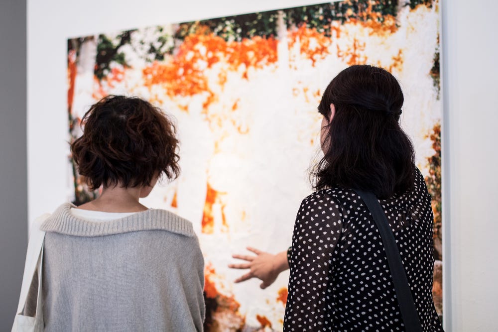 women looking at artwork