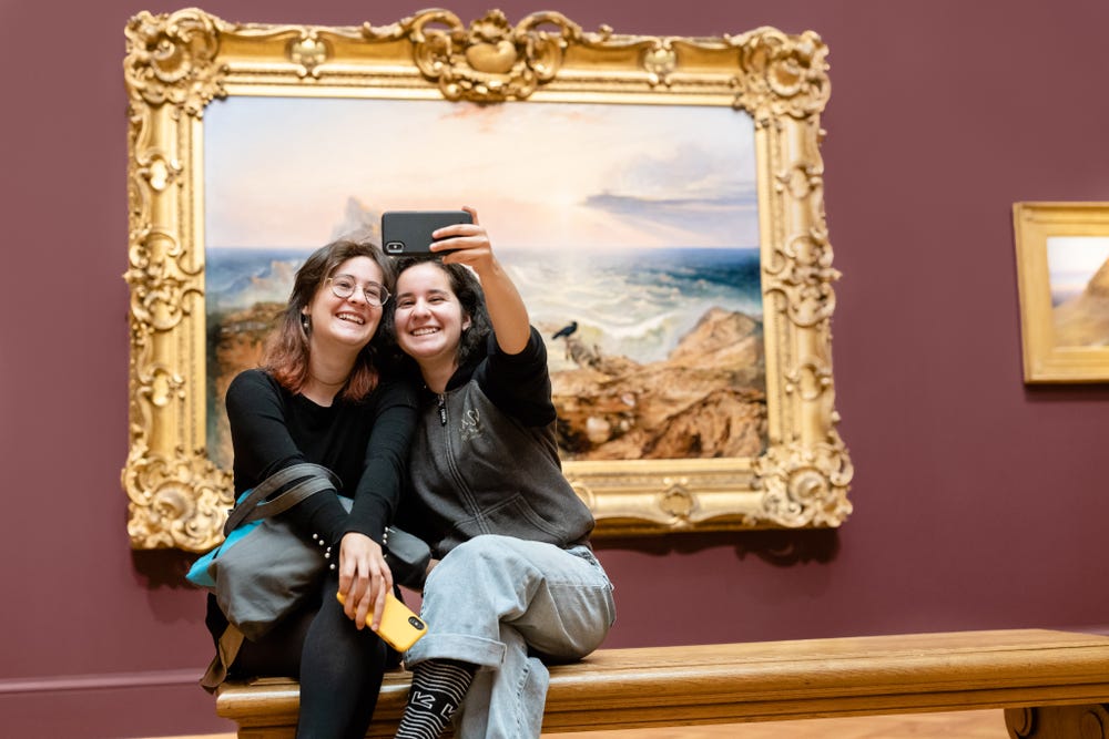 two teens taking a selfie in the Legion of Honor