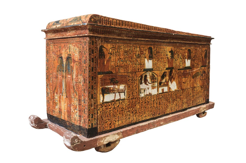 Wood coffin adorned with decorations in the de Young's Ramses exhibition