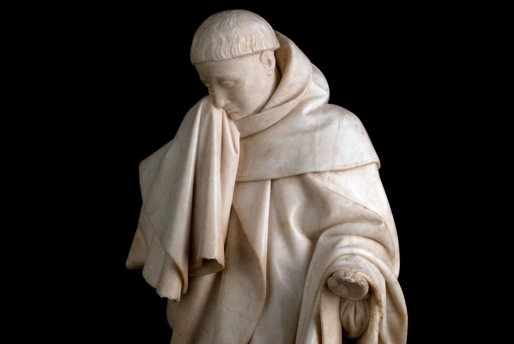 Sculpture of man in mourning.