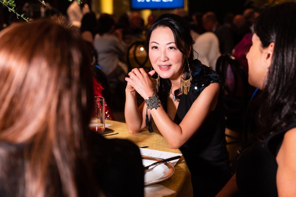 woman at table at black tie dinner