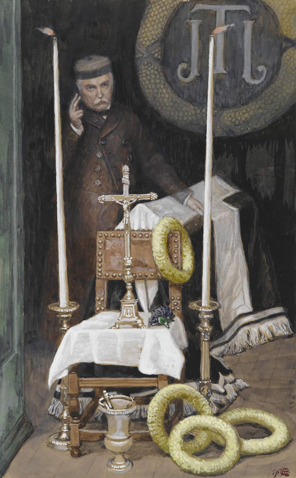 Man behind a table with Jesus on the cross in between two large candlesticks