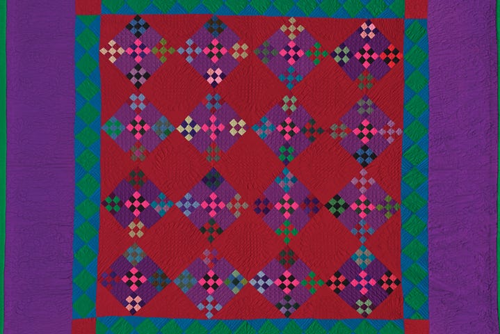 quilt with lush colors and a pattern with squares and diamonds