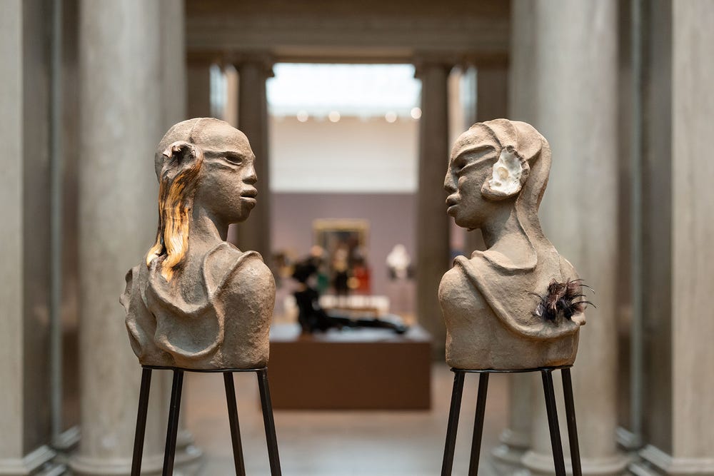 two busts facing each other
