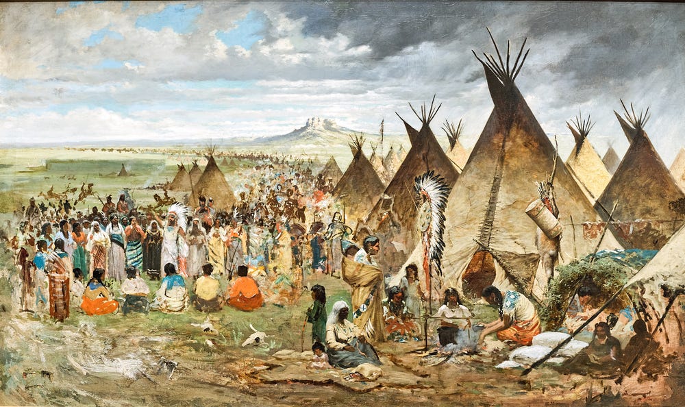 Many people gathered together near several tipis
