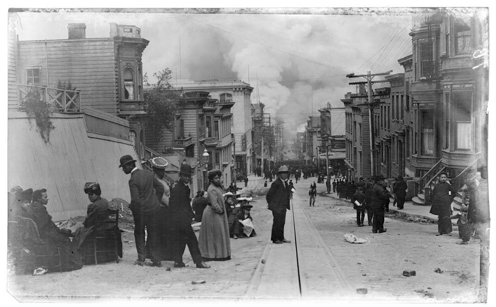 street scene of people watching approaching fire