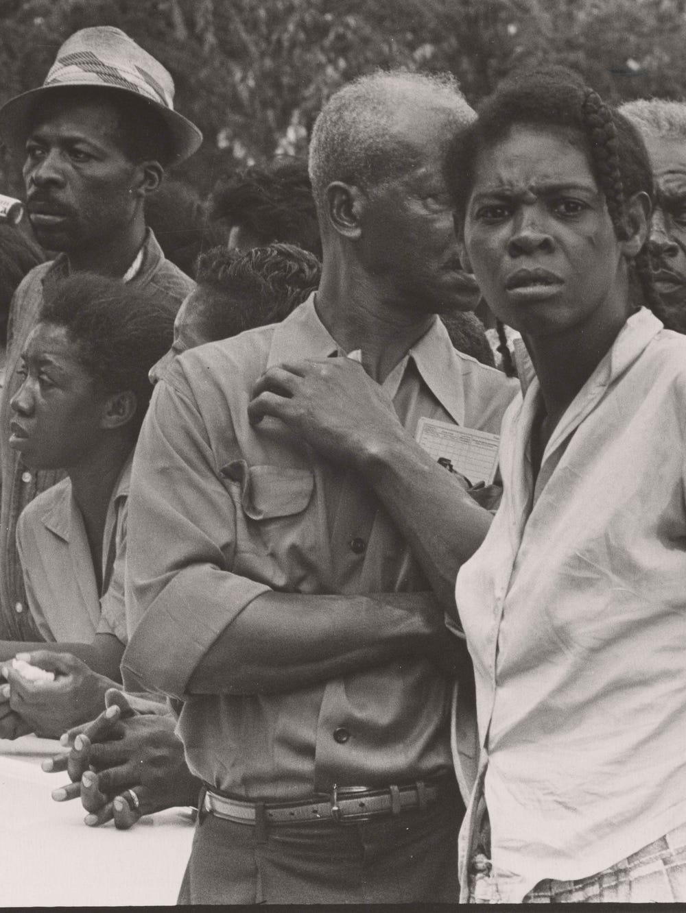 Group of Black people watching the funeral procession