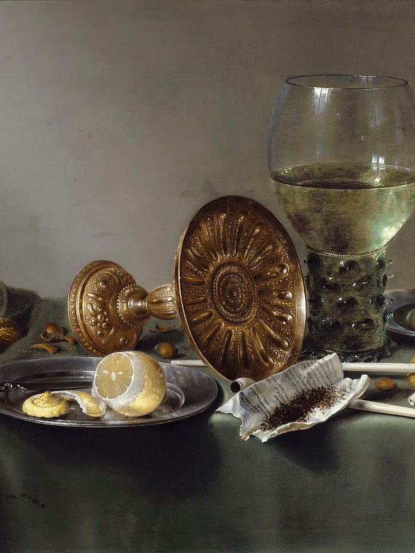 Goblets, fruit, and other objects on a table.