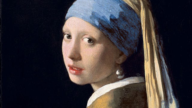 Girl wearing headwrap and pearl earring.
