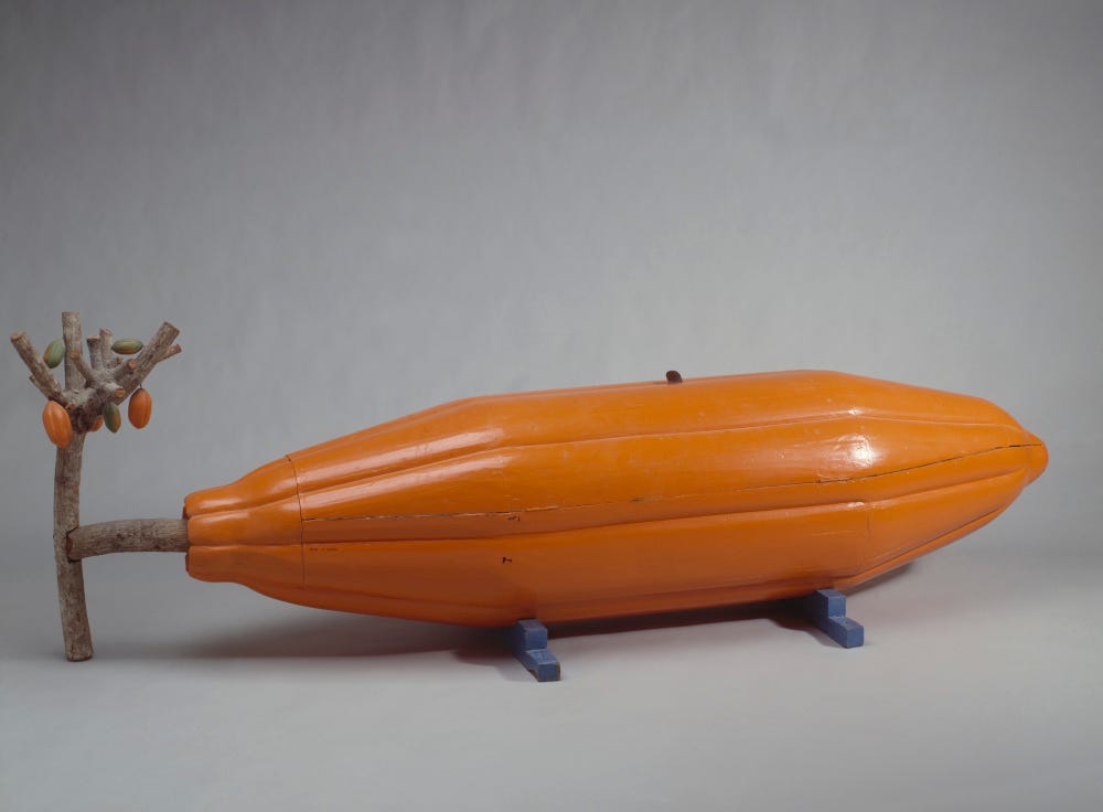 Orange coffin in the shape of a cocoa pod