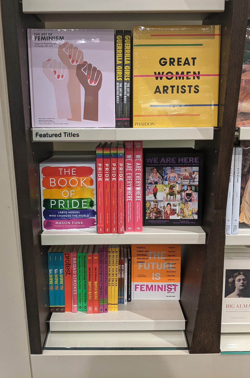 three rows of books in a bookshelf featuring women artists and contemporary-museum culture
