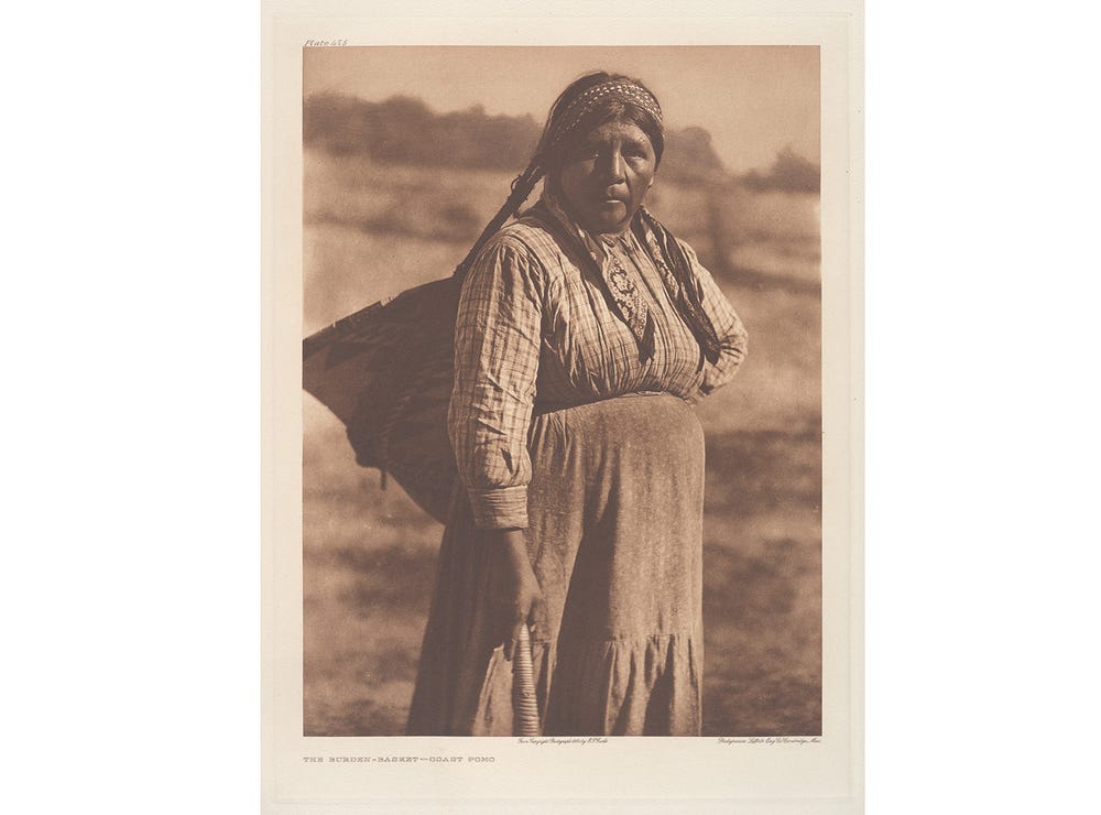 Pomo woman carrying a basket on her back