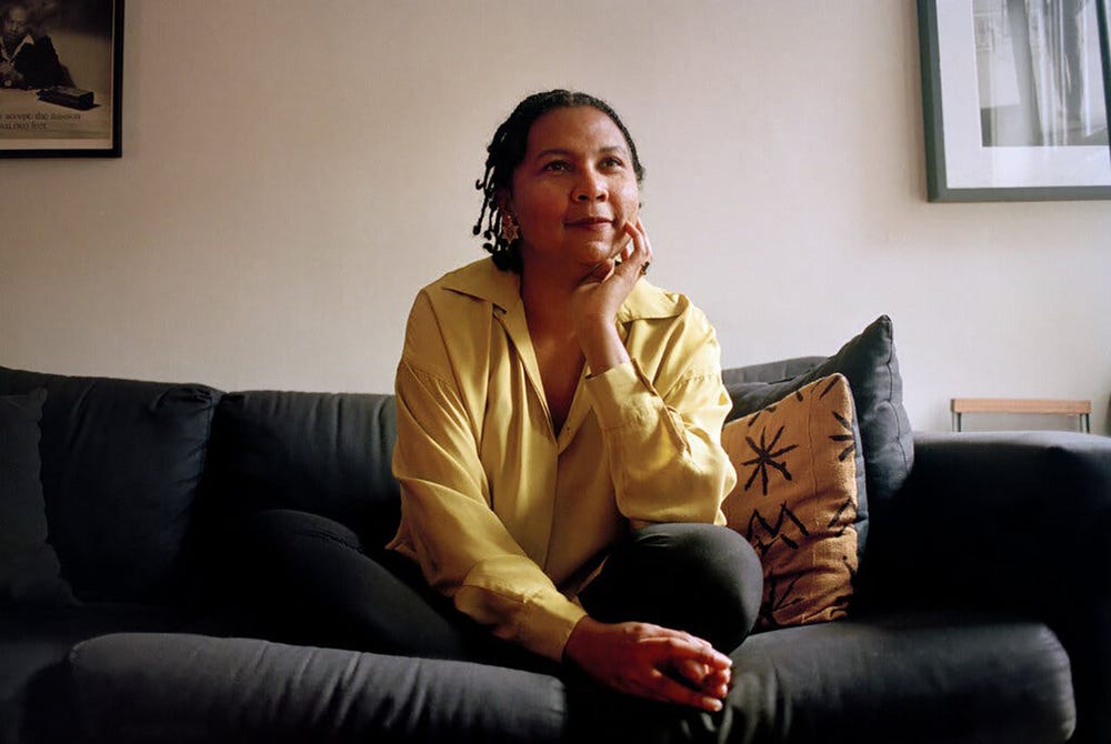 bell hooks sitting on a couch looking pensive