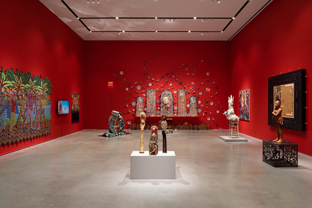 gallery with red walls and artwork