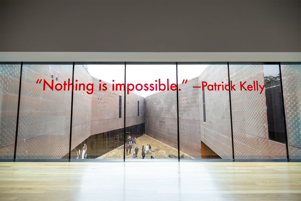 "Nothing is Impossible" decal on de Young museum windows