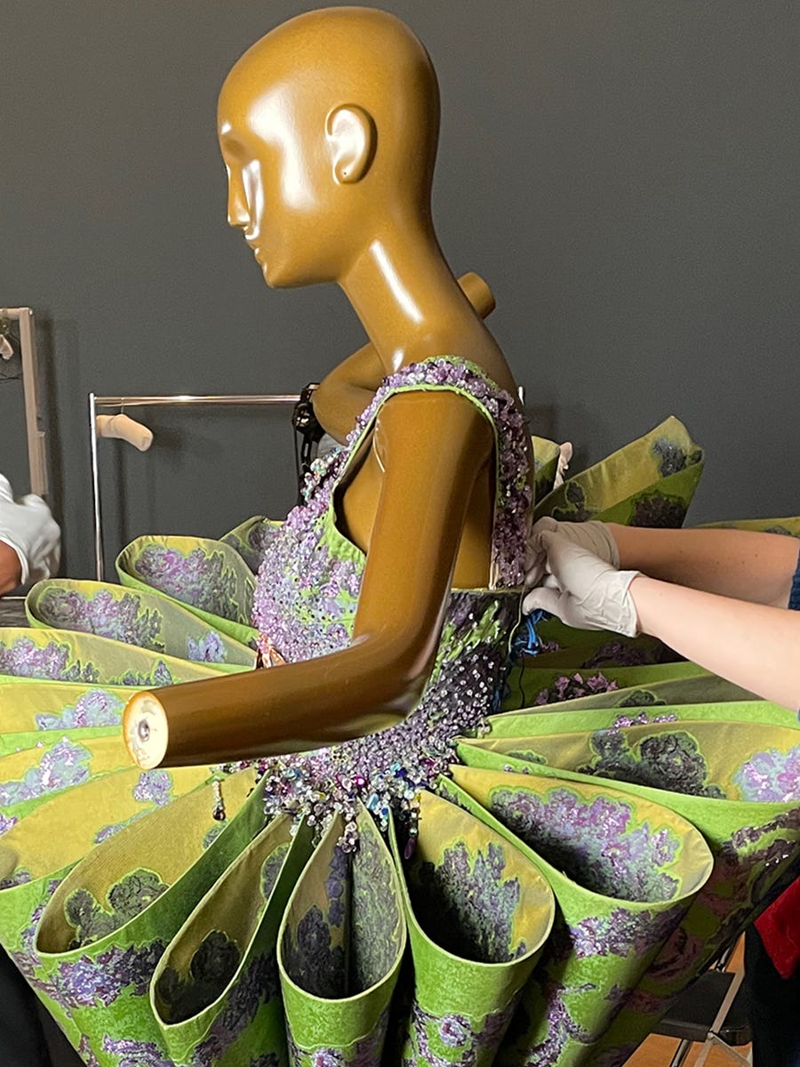 People working to preserve fashion piece on mannequin