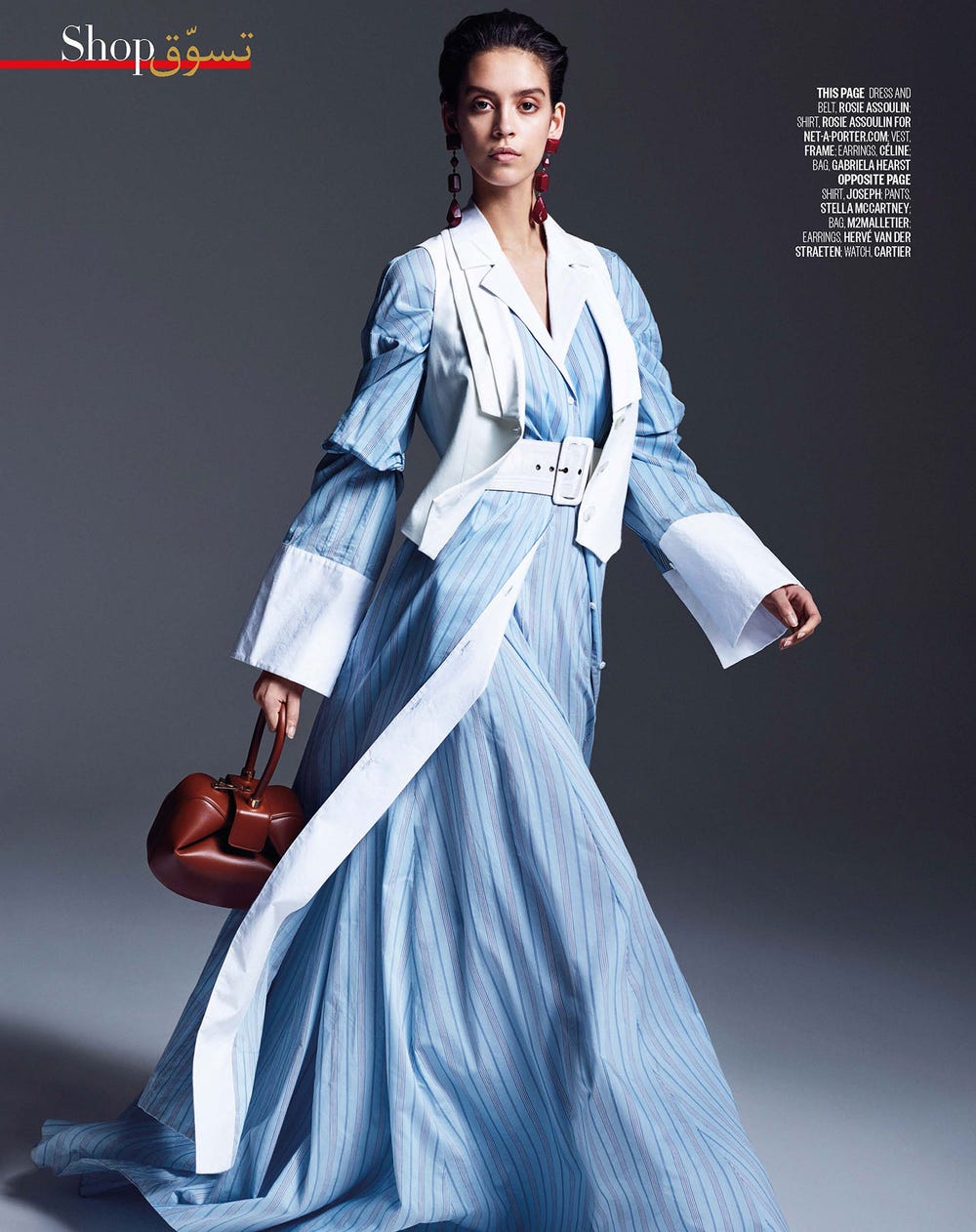 cover of Vogue Arabia: model wears a dress designed like a men's shirt, with a belt, vest, earrings, and bag