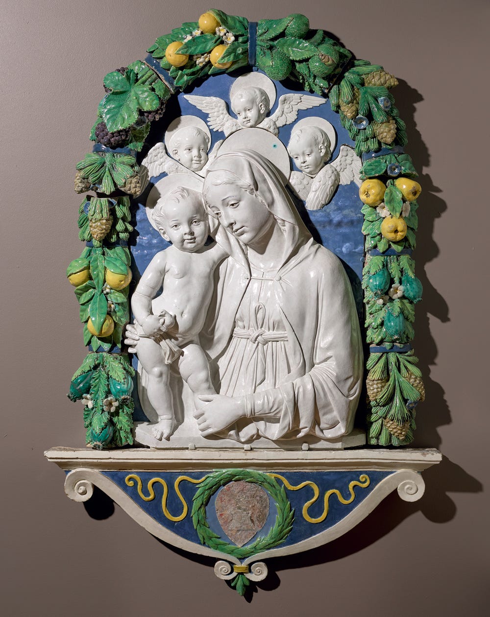 Virgin Mary and child relief with angels and garland