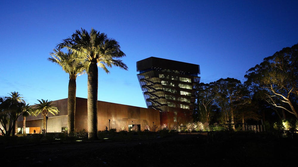 Exterior of de Young at night.