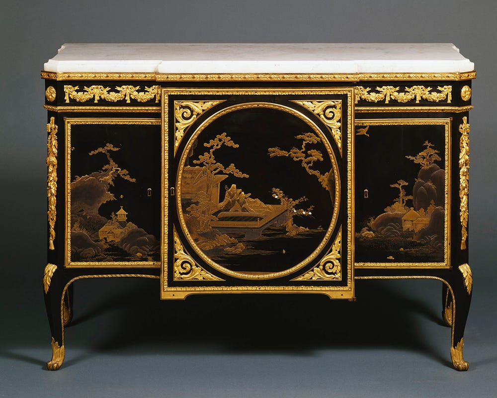 legged piece of furniture with gold and black lacquer