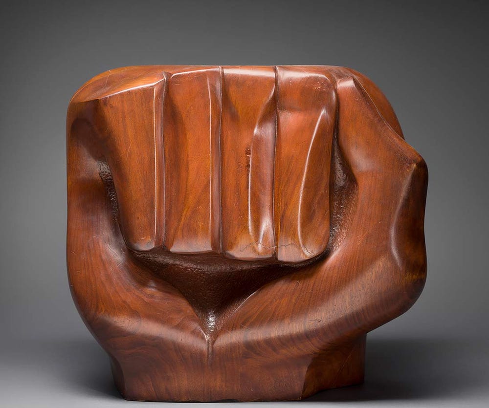 carved wooden fist