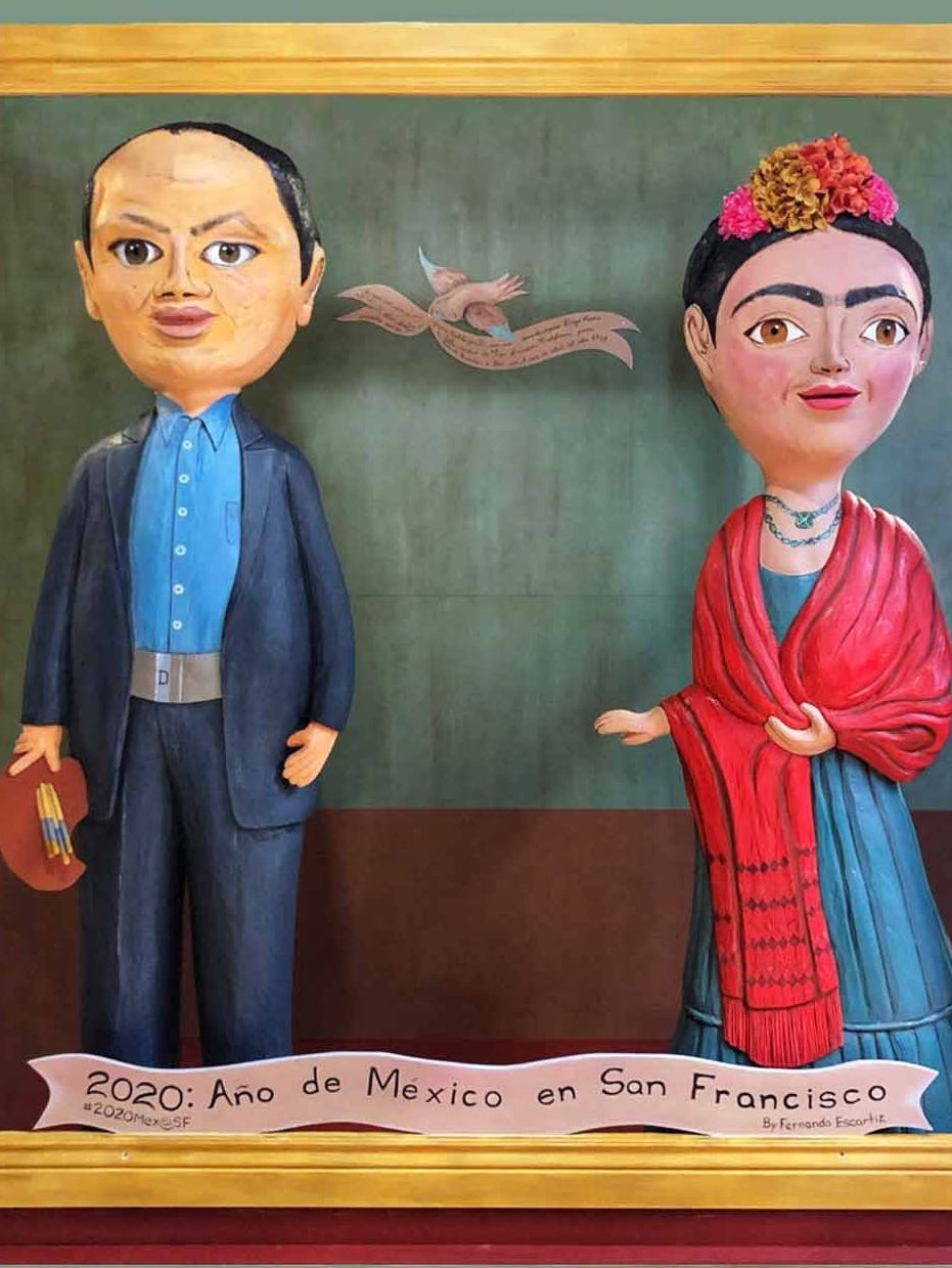 Two small dolls, including a Frida Kahlo doll