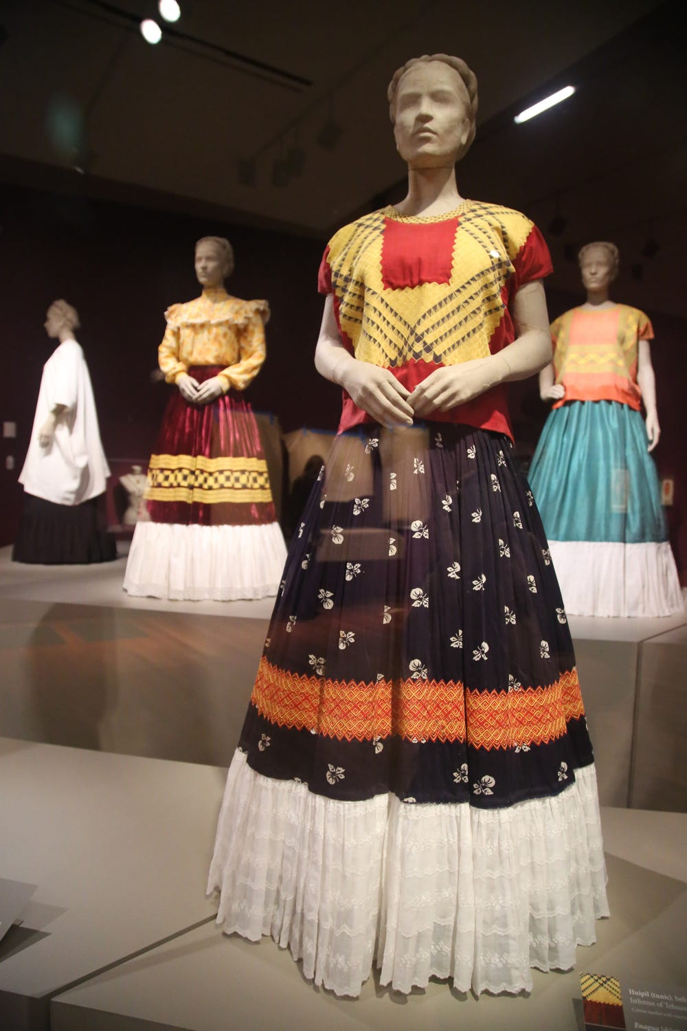 mannequins wearing blouses and floor-length skirts
