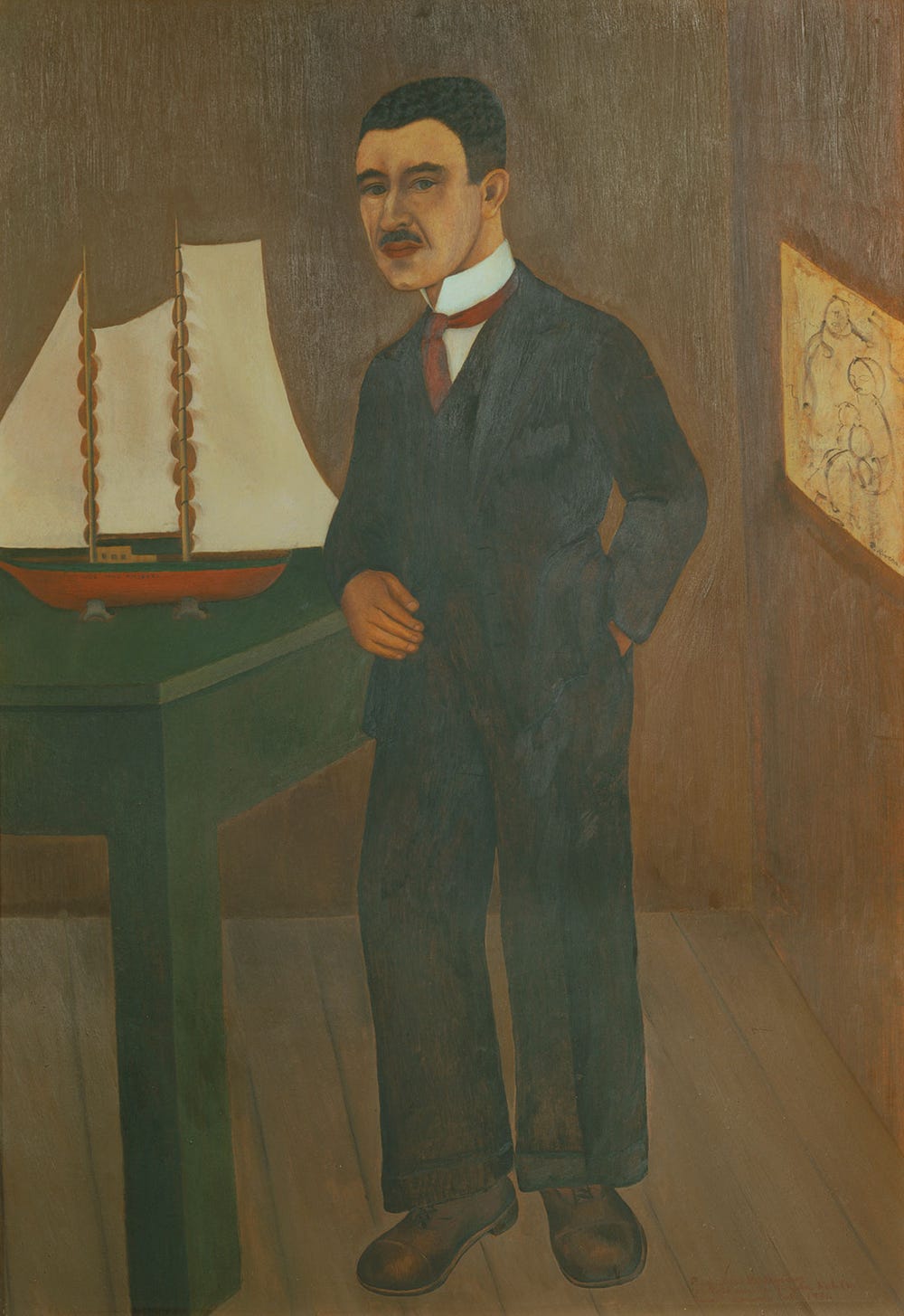 portrait of a man with dark hair in a suit, with a model sailboat and painting in the background