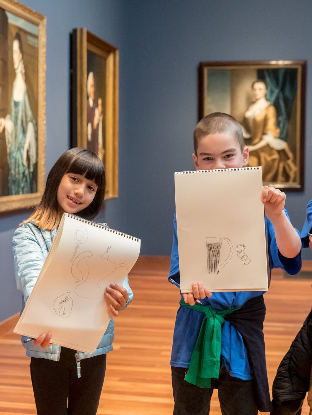 Students holding up drawings