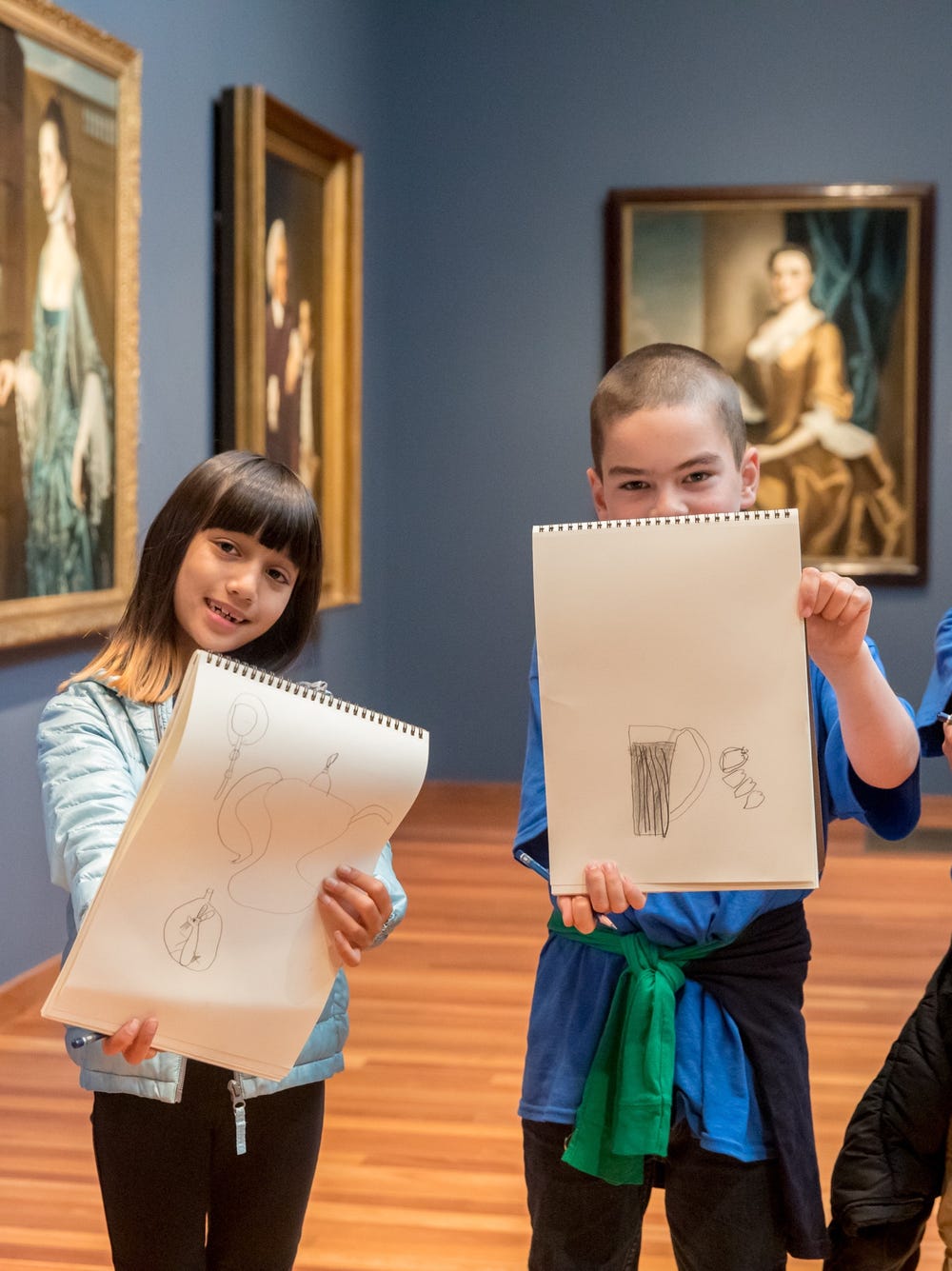 Students holding up drawings